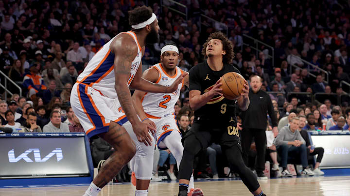 Apr 11, 2025; New York, New York, USA; Cleveland Cavaliers guard Craig Porter Jr. (9) drives to the basket against New York Knicks center Mitchell Robinson (23) and guard Miles McBride (2) during the first quarter at Madison Square Garden. Mandatory Credit: Brad Penner-Imagn Images Apr 11, 2025; New York, New York, USA; Cleveland Cavaliers guard Craig Porter Jr. (9) drives to the basket against New York Knicks center Mitchell Robinson (23) and guard Miles McBride (2) during the first quarter at Madison Square Garden. Mandatory Credit: Brad Penner-Imagn Images
