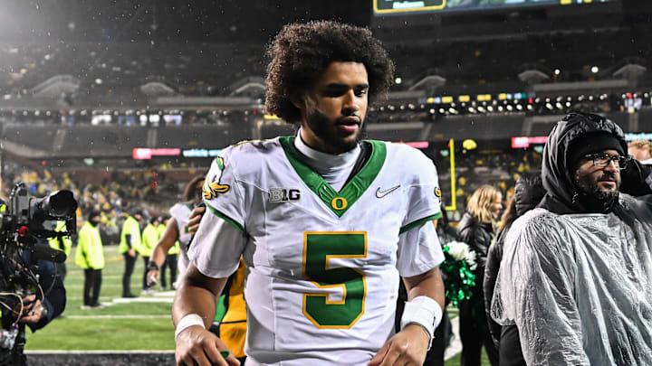 Nov 8, 2025; Iowa City, Iowa, USA; Oregon Ducks quarterback Dante Moore (5) runs off the field after the game against the Iowa Hawkeyes at Kinnick Stadium. Mandatory Credit: Jeffrey Becker-Imagn Images