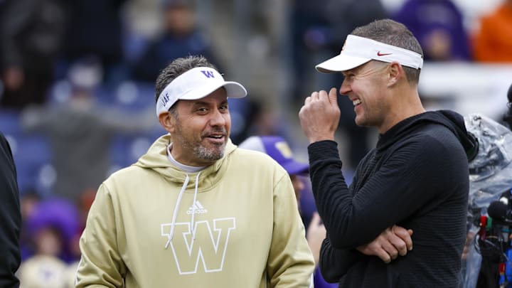 Nov 2, 2024; Seattle, Washington, USA; Washington Huskies head coach Jedd Fisch, left, talks with USC Trojans head coach Lincoln Riley during pregame warmups at Alaska Airlines Field at Husky Stadium. Mandatory Credit: Joe Nicholson-Imagn Images Nov 2, 2024; Seattle, Washington, USA; Washington Huskies head coach Jedd Fisch, left, talks with USC Trojans head coach Lincoln Riley during pregame warmups at Alaska Airlines Field at Husky Stadium. Mandatory Credit: Joe Nicholson-Imagn Images