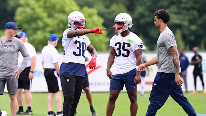 Jun 12, 2024; Foxborough, MA, USA;  New England Patriots running back Rhamondre Stevenson (38) and running back Deshaun Fenwick (35) work out at minicamp at Gillette Stadium.  Mandatory Credit: Eric Canha-USA TODAY Sports