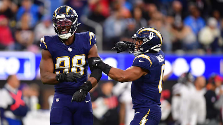 Dec 27, 2025; Inglewood, California, USA;  Los Angeles Chargers linebacker Odafe Oweh (98) and linebacker Daiyan Henley (0) react after a defensive play against the Houston Texans during the second half at SoFi Stadium. Mandatory Credit: Gary A. Vasquez-Imagn Images