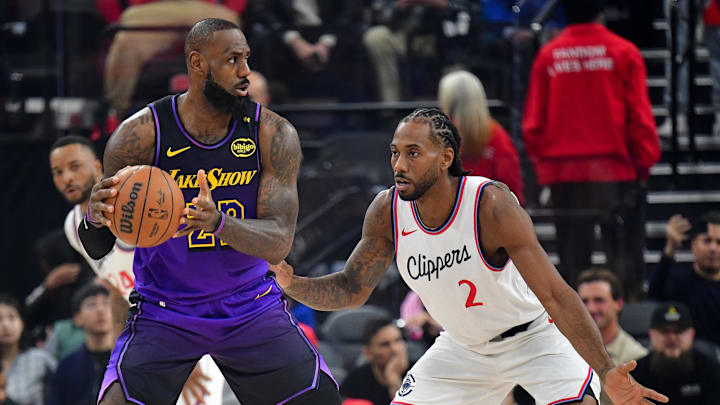 Jan 19, 2025; Inglewood, California, USA; Los Angeles Lakers forward LeBron James (23) moves the ball against Los Angeles Clippers forward Kawhi Leonard (2) during the first half at Intuit Dome. 