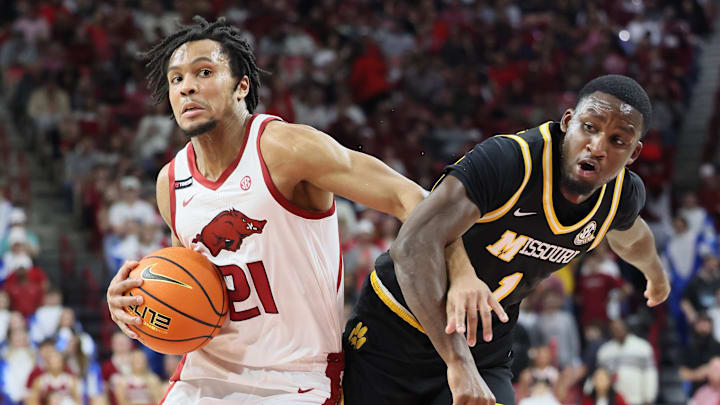 Feb 22, 2025; Fayetteville, Arkansas, USA; Arkansas Razorbacks guard D.J. Wagner (21) drives against Missouri Tigers guard Marques Warrick (1) during the first half at Bud Walton Arena. Mandatory Credit: Nelson Chenault-Imagn Images Feb 22, 2025; Fayetteville, Arkansas, USA; Arkansas Razorbacks guard D.J. Wagner (21) drives against Missouri Tigers guard Marques Warrick (1) during the first half at Bud Walton Arena. Mandatory Credit: Nelson Chenault-Imagn Images