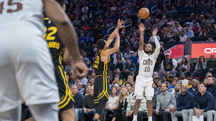 Nov 11, 2023; San Francisco, California, USA;  Cleveland Cavaliers guard Darius Garland (10) shoots a three point basket over Golden State Warriors guard Stephen Curry (30) during the second quarter at Chase Center. Mandatory Credit: Neville E. Guard-Imagn Images