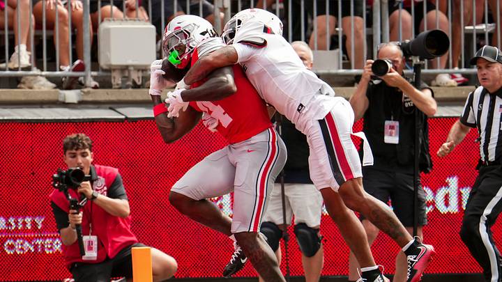 Ohio State Buckeyes wide receiver Jeremiah Smith (4) catches a touchdown pass defended by Ball State Cardinals defensive back Sterling Smith (1) during the NCAA football game at Ohio Stadium in Columbus on Sept. 5, 2026.