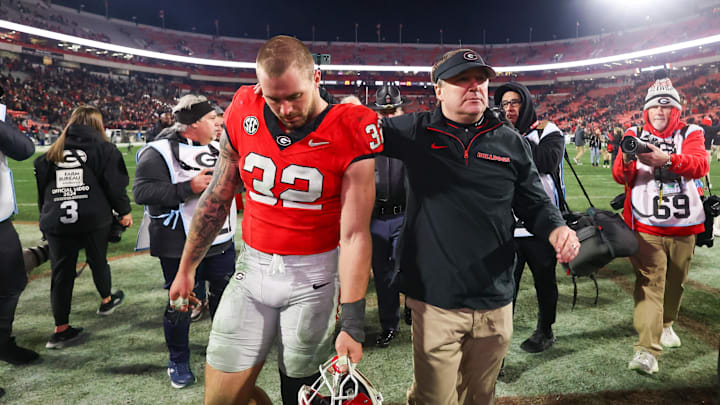 Nov 29, 2024; Athens, Georgia, USA; Georgia Bulldogs linebacker Chaz Chambliss (32) and head coach Kirby Smart walk off the field after an eight overtime victory over the Georgia Tech Yellow Jackets at Sanford Stadium. Mandatory Credit: Brett Davis-Imagn Images