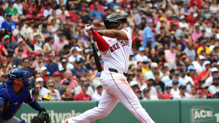 Jul 14, 2024; Boston, Massachusetts, USA;  Boston Red Sox third baseman Rafael Devers (11) hits a double during the third inning against the Kansas City Royals at Fenway Park. Mandatory Credit: Bob DeChiara-USA TODAY Sports