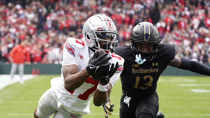 Nov 16, 2024; Chicago, Illinois, USA; Ohio State Buckeyes wide receiver Carnell Tate (17) catches a touchdown pass as Northwestern Wildcats defensive back Josh Fussell (13) defends during the first half at Wrigley Field. Mandatory Credit: David Banks-Imagn Images