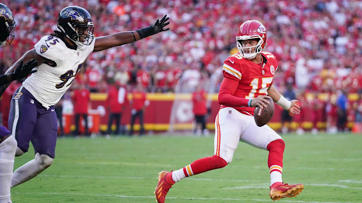 Sep 28, 2025; Kansas City, Missouri, USA;  Kansas City Chiefs quarterback Patrick Mahomes (15) looks to pass as Baltimore Ravens linebacker Tavius Robinson (95) defends at GEHA Field at Arrowhead Stadium. Mandatory Credit: Denny Medley-Imagn Images