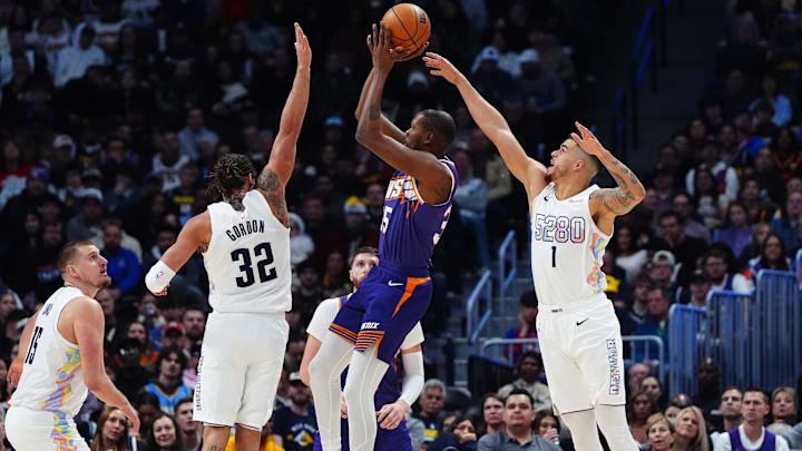 Dec 23, 2024; Denver, Colorado, USA; Denver Nuggets forward Aaron Gordon (32) and forward Michael Porter Jr. (1) and center Nikola Jokic (15) defend on Phoenix Suns forward Kevin Durant (35) in the second half at Ball Arena. 