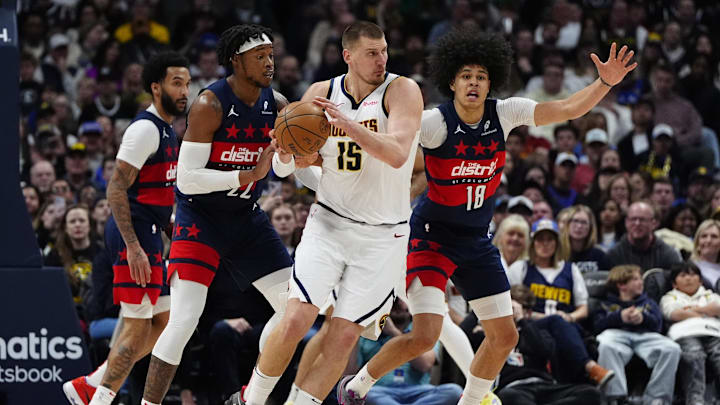 Mar 15, 2025; Denver, Colorado, USA; Washington Wizards forward Richaun Holmes (22) and forward Kyshawn George (18) defend on Denver Nuggets center Nikola Jokic (15) in the second half at Ball Arena. Mandatory Credit: Ron Chenoy-Imagn Images Mar 15, 2025; Denver, Colorado, USA; Washington Wizards forward Richaun Holmes (22) and forward Kyshawn George (18) defend on Denver Nuggets center Nikola Jokic (15) in the second half at Ball Arena. Mandatory Credit: Ron Chenoy-Imagn Images