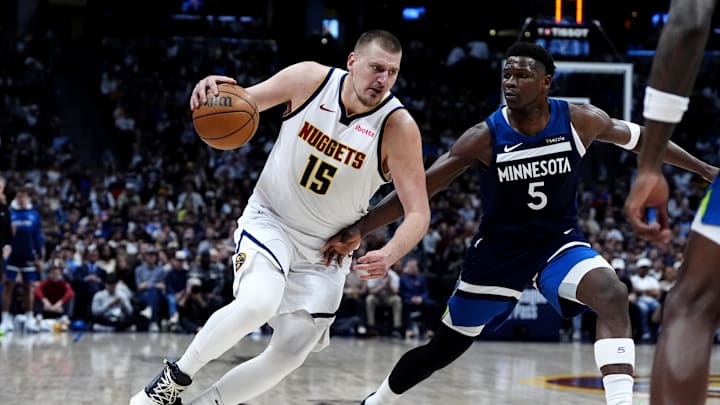 Mar 12, 2025; Denver, Colorado, USA; Minnesota Timberwolves guard Anthony Edwards (5) defends Denver Nuggets center Nikola Jokic (15) in the second half at Ball Arena. Mandatory Credit: Ron Chenoy-Imagn Images
