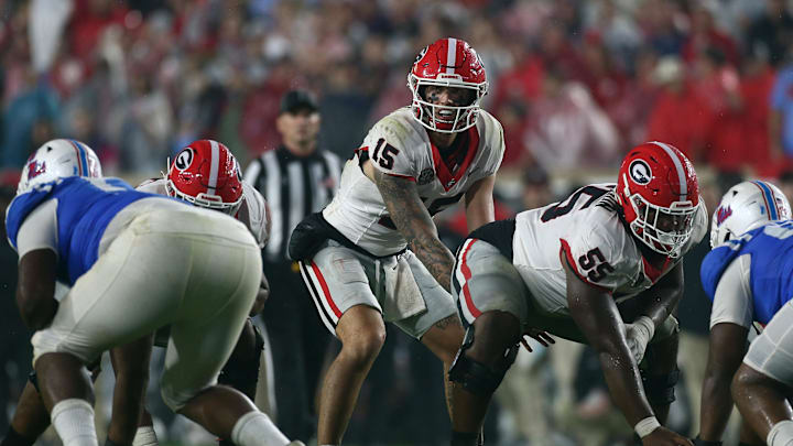 Nov 9, 2024; Oxford, Mississippi, USA; Georgia Bulldogs quarterback Carson Beck (15) waits to receive the snap from offensive lineman Jared Wilson (55) during the second half against the Mississippi Rebels at Vaught-Hemingway Stadium. Mandatory Credit: Petre Thomas-Imagn Images