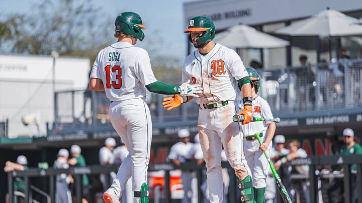 Miami Hurricanes catcher Alex Sosa (13) and right fielder Derek Williams (2) against Lafayette Miami Hurricanes catcher Alex Sosa (13) and right fielder Derek Williams (2) against Lafayette