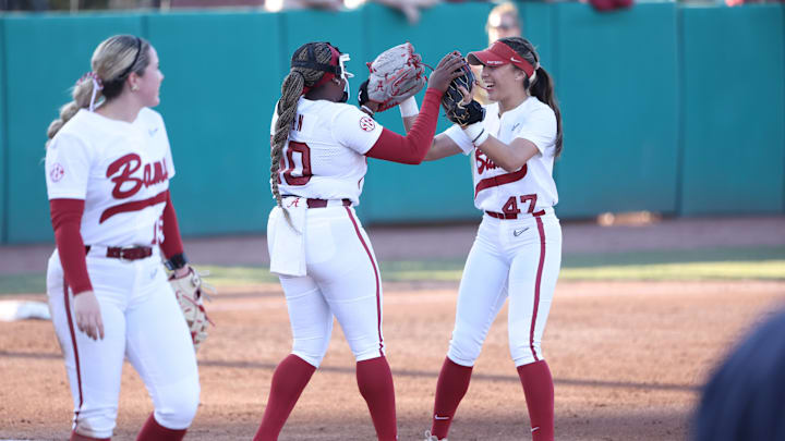 Alabama pitcher Vic Moten high fives with infielder Salen Hawkins