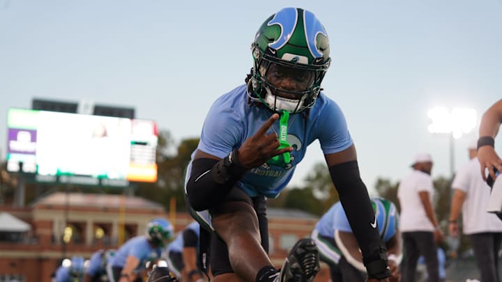 A Tulane Green Wave players stretches for a game against the Charlotte 49ers. A Tulane Green Wave players stretches for a game against the Charlotte 49ers.