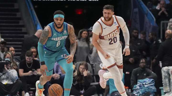 Mar 15, 2024; Charlotte, North Carolina, USA; Charlotte Hornets forward Miles Bridges (0) brings the ball up court after a steal trailed by Phoenix Suns center Jusuf Nurkic (20) during the second half at Spectrum Center. Mandatory Credit: Jim Dedmon-Imagn Images Mar 15, 2024; Charlotte, North Carolina, USA; Charlotte Hornets forward Miles Bridges (0) brings the ball up court after a steal trailed by Phoenix Suns center Jusuf Nurkic (20) during the second half at Spectrum Center. Mandatory Credit: Jim Dedmon-Imagn Images