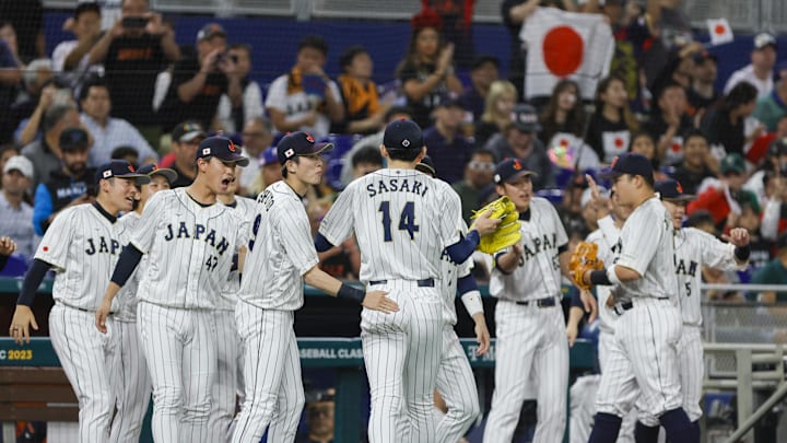 Japan starting pitcher Roki Sasaki (14) celebrates with teammates after the first inning against Mexico at LoanDepot Park in 2023.
