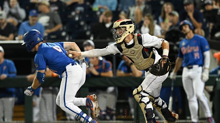 Jun 15, 2024; Omaha, NE, USA; Texas A&M Aggies catcher Jackson Appel (20) tags out Florida Gators second baseman Cade Kurland (4) after a strike out during the third inning at Charles Schwab Field Omaha. Mandatory Credit: Steven Branscombe-Imagn Images Jun 15, 2024; Omaha, NE, USA; Texas A&M Aggies catcher Jackson Appel (20) tags out Florida Gators second baseman Cade Kurland (4) after a strike out during the third inning at Charles Schwab Field Omaha. Mandatory Credit: Steven Branscombe-Imagn Images