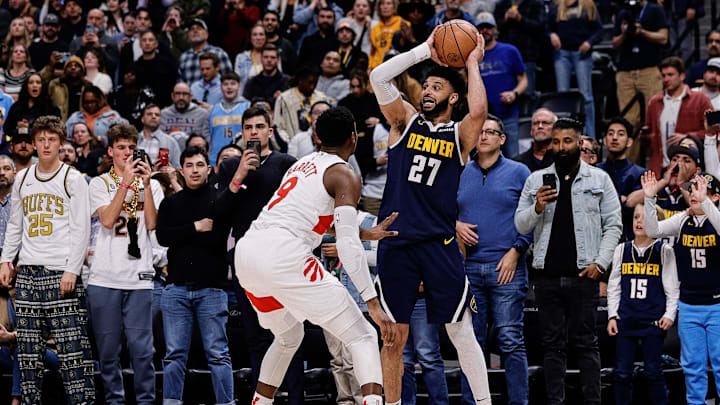Mar 11, 2024; Denver, Colorado, USA; Denver Nuggets guard Jamal Murray (27) controls the ball as Toronto Raptors guard RJ Barrett (9) guards in the fourth quarter at Ball Arena. Mandatory Credit: Isaiah J. Downing-Imagn Images