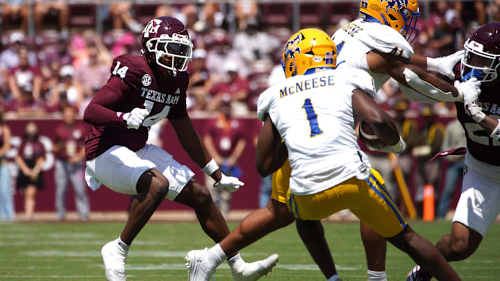Sep 7, 2024; College Station, Texas, USA; Texas A&M Aggies defensive back Jayvon Thomas (14) looks to tackle McNeese State Cowboys running back D'Angelo Durham (1) during the second quarter at Kyle Field. Mandatory Credit: Dustin Safranek-Imagn Images