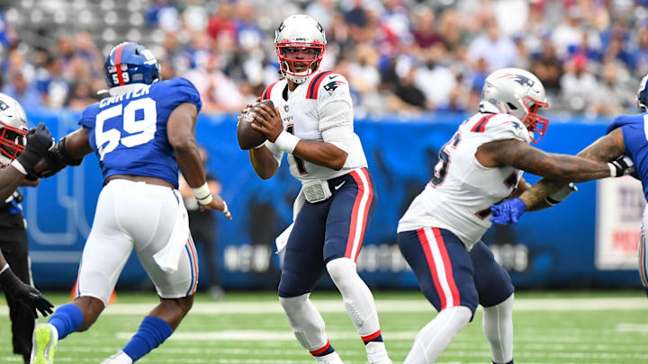 Aug 29, 2021; East Rutherford, New Jersey, USA;  New England Patriots quarterback Cam Newton (1) looks for an open receiver against the New York Giants at MetLife Stadium. Mandatory Credit: Dennis Schneidler-Imagn Images