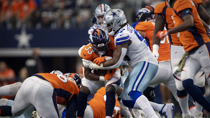 Nov 7, 2021; Arlington, Texas, USA; Denver Broncos running back Javonte Williams (33) is tackled by Dallas Cowboys defensive tackle Osa Odighizuwa (97) during the first quarter at AT&T Stadium. Mandatory Credit: Jerome Miron-Imagn Images Nov 7, 2021; Arlington, Texas, USA; Denver Broncos running back Javonte Williams (33) is tackled by Dallas Cowboys defensive tackle Osa Odighizuwa (97) during the first quarter at AT&T Stadium. Mandatory Credit: Jerome Miron-Imagn Images