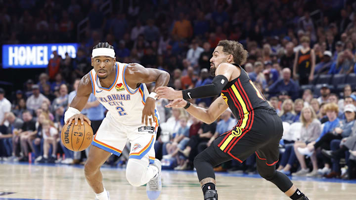Oct 27, 2024; Oklahoma City, Oklahoma, USA; Oklahoma City Thunder guard Shai Gilgeous-Alexander (2) drives to the basket around Atlanta Hawks guard Trae Young (11) during the second half at Paycom Center. Mandatory Credit: Alonzo Adams-Imagn Images
