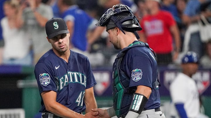 Seattle Mariners relief pitcher Matt Brash (47) celebrates with catcher Cal Raleigh (29) against the Kansas City Royals after the game at Kauffman Stadium in 2023.