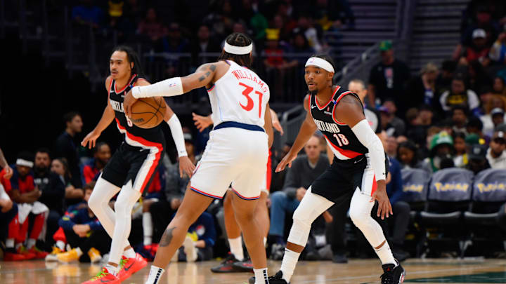 Oct 11, 2024; Seattle, Washington, USA; Portland Trail Blazers guard Devonte Graham (18) guards Los Angeles Clippers guard Alondes Williams (31) during the second half at Climate Pledge Arena. Mandatory Credit: Steven Bisig-Imagn Images