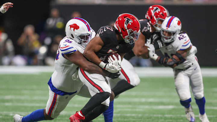 Atlanta Falcons running back Bijan Robinson (7) is tackled by Buffalo Bills defensive tackle Deone Walker (96) during the second half of a game at Mercedes-Benz Stadium.