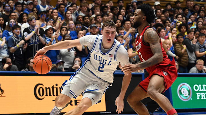 Jan 27, 2025; Durham, North Carolina, USA; Duke Blue Devils forward Cooper Flagg (2) drives against North Carolina State Wolfpack guard Dontrez Styles (3) during the second half at Cameron Indoor Stadium.  The Blue Devils won 74-64. Mandatory Credit: Rob Kinnan-Imagn Images