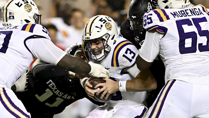 Oct 26, 2024; College Station, Texas, USA; LSU Tigers quarterback Garrett Nussmeier (13) is sacked by Texas A&M Aggies defensive lineman Nic Scourton (11) in the fourth quarter at Kyle Field. Mandatory Credit: Maria Lysaker-Imagn Images. 