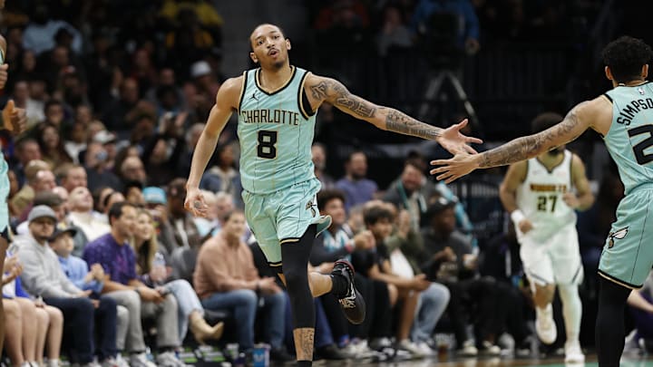 Feb 1, 2025; Charlotte, North Carolina, USA; Charlotte Hornets guard Nick Smith Jr. (8) celebrates after making a shot during the second quarter against the Denver Nuggets at Spectrum Center. Mandatory Credit: Brian Westerholt-Imagn Images