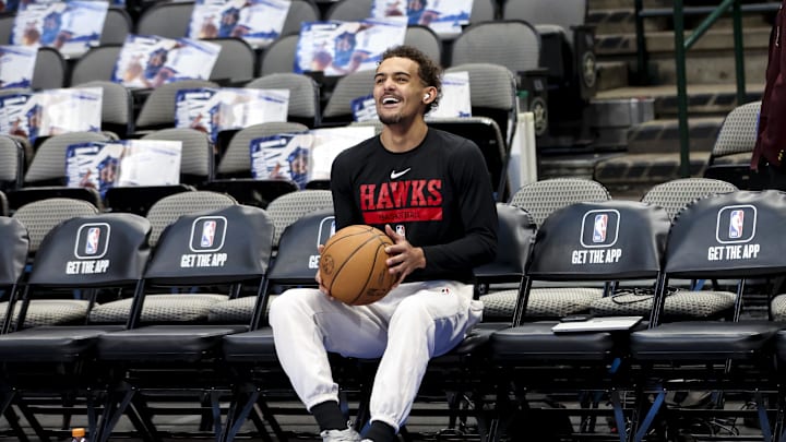 Trae Young laughing on the bench before a game against the Dallas Mavericks