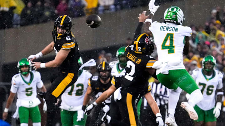 Iowa Hawkeyes defensive back Zach Lutmer (6) and Iowa Hawkeyes defensive back TJ Hall (2) defend a pass meant for Oregon Ducks wide receiver Malik Benson (4) Nov. 8, 2025 during a Big Ten Football game at Kinnick Stadium in Iowa City, Iowa.