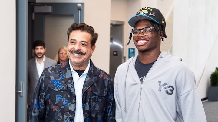 The Jacksonville Jaguars first-round pick, Colorado Buffaloes wide receiver and defensive back Travis Hunter, right, was greeted by Jaguars owner Shahid Khan, left, after Hunter arrived on Friday, March 25, 2025 at Miller Electric Center in Jacksonville, Fla. The team traded up from fifth to second after making a deal with the Cleveland Browns on Thursday night. [Doug Engle/Florida Times-Union]
