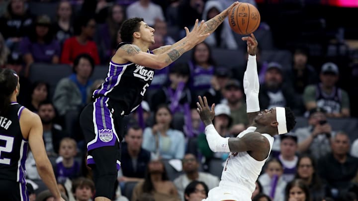 Feb 7, 2026; Sacramento, California, USA; Sacramento Kings guard Nique Clifford (5) blocks the shot from Cleveland Cavaliers guard Dennis Schroder (8) during the first quarter at Golden 1 Center.