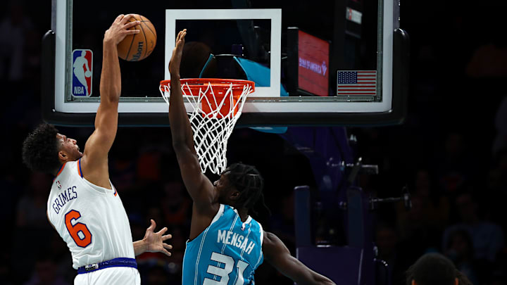 Quentin Grimes of the New York Knicks dunking on Nathan Mensah of the Charlotte Hornets