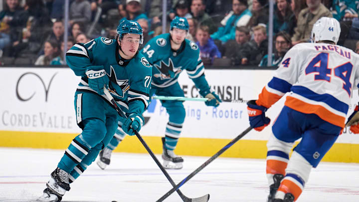 Mar 8, 2025; San Jose, California, USA; San Jose Sharks center Macklin Celebrini (71) plays the puck against New York Islanders center Jean-Gabriel Pageau (44) during the second period at SAP Center at San Jose. Mandatory Credit: Robert Edwards-Imagn Images