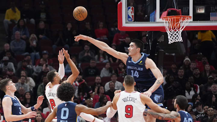 Oct 12, 2024; Chicago, Illinois, USA; Memphis Grizzlies center Zach Edey (14) defends Chicago Bulls guard Zach LaVine (8) during the first half at United Center. Mandatory Credit: David Banks-Imagn Images