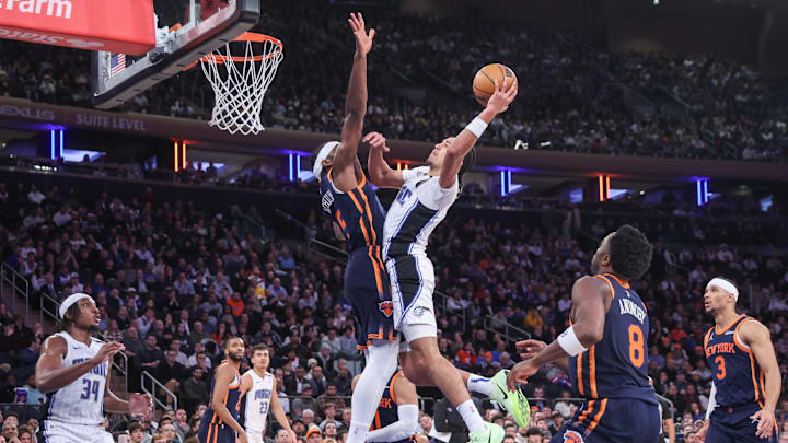 Jan 6, 2025; New York, New York, USA;  Orlando Magic guard Anthony Black (0) looks to drive past New York Knicks forward Precious Achiuwa (5) in the fourth quarter at Madison Square Garden. Mandatory Credit: Wendell Cruz-Imagn Images