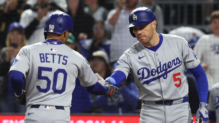 Sep 4, 2025; Pittsburgh, Pennsylvania, USA; Los Angeles Dodgers first baseman Freddie Freeman (5) congratulates shortstop Mookie Betts (50) crossing home plate on a solo home run against the Pittsburgh Pirates during the ninth inning at PNC Park. Mandatory Credit: Charles LeClaire-Imagn Images Sep 4, 2025; Pittsburgh, Pennsylvania, USA; Los Angeles Dodgers first baseman Freddie Freeman (5) congratulates shortstop Mookie Betts (50) crossing home plate on a solo home run against the Pittsburgh Pirates during the ninth inning at PNC Park. Mandatory Credit: Charles LeClaire-Imagn Images