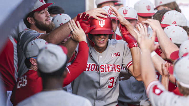 Indiana's Jake Hanley is congratulated by teammates in the dugout after he hit a home run against Michigan on Thursday.