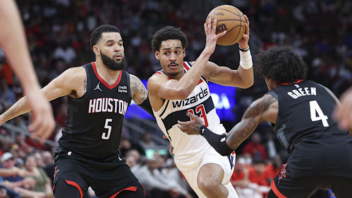 Mar 14, 2024; Houston, Texas, USA; Washington Wizards guard Jordan Poole (13) drives with the ball as Houston Rockets guard Fred VanVleet (5) and guard Jalen Green (4) defend during the third quarter at Toyota Center. Mandatory Credit: Troy Taormina-Imagn Images