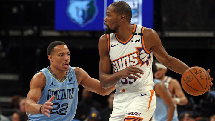 Feb 25, 2025; Memphis, Tennessee, USA; Phoenix Suns forward Kevin Durant (35) handles the ball as Memphis Grizzlies guard Desmond Bane (22) defends during the first quarter at FedExForum. Mandatory Credit: Petre Thomas-Imagn Images