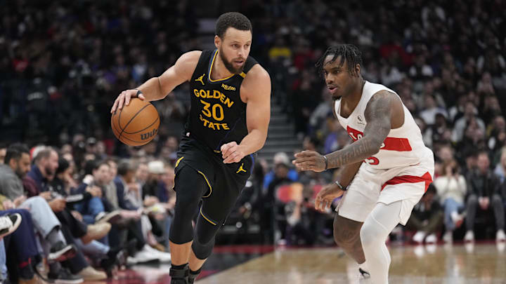 Jan 13, 2025; Toronto, Ontario, CAN; Golden State Warriors guard Stephen Curry (30) dribbles past Toronto Raptors guard Davion Mitchell (45) during the second half at Scotiabank Arena. Mandatory Credit: John E. Sokolowski-Imagn Images