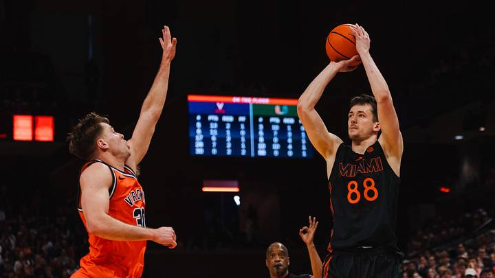 Feb 21, 2026; Charlottesville, Virginia, USA; Miami (FL) Hurricanes forward Timo Malovec (88) shoots the ball while Virginia Cavaliers guard Dallin Hall (30) defends during the first half at John Paul Jones Arena. Mandatory Credit: Emily Faith Morgan-Imagn Images