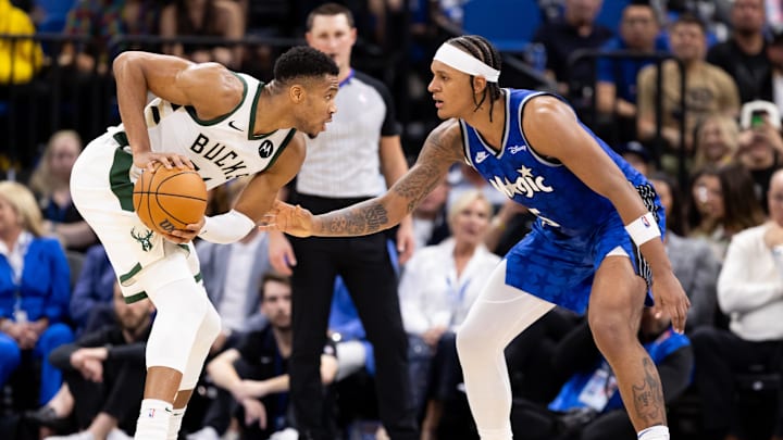 Milwaukee Bucks forward Giannis Antetokounmpo (34) stares at Orlando Magic forward Paolo Banchero (5) during the first half at Amway Center.