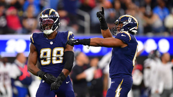 Dec 27, 2025; Inglewood, California, USA;  Los Angeles Chargers linebacker Odafe Oweh (98) and linebacker Daiyan Henley (0) react after a defensive play against the Houston Texans during the second half at SoFi Stadium. Mandatory Credit: Gary A. Vasquez-Imagn Images